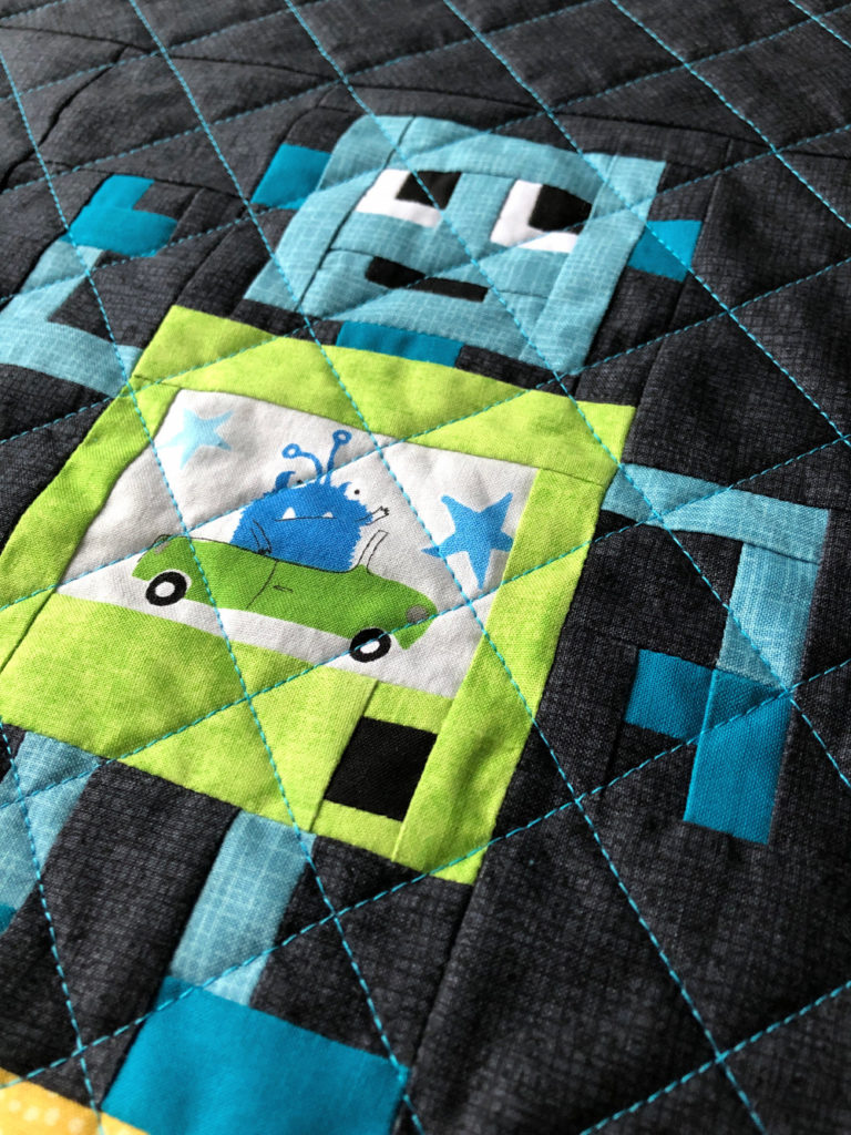 Rocking Robots embroidery tutorial - robot quilt block with fussy-cut monster driving a car