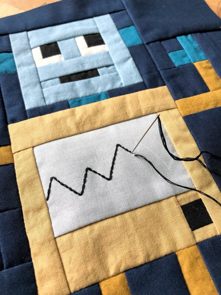 Rocking Robots embroidery tutorial - hand stitching a zig zag line onto robot quilt block