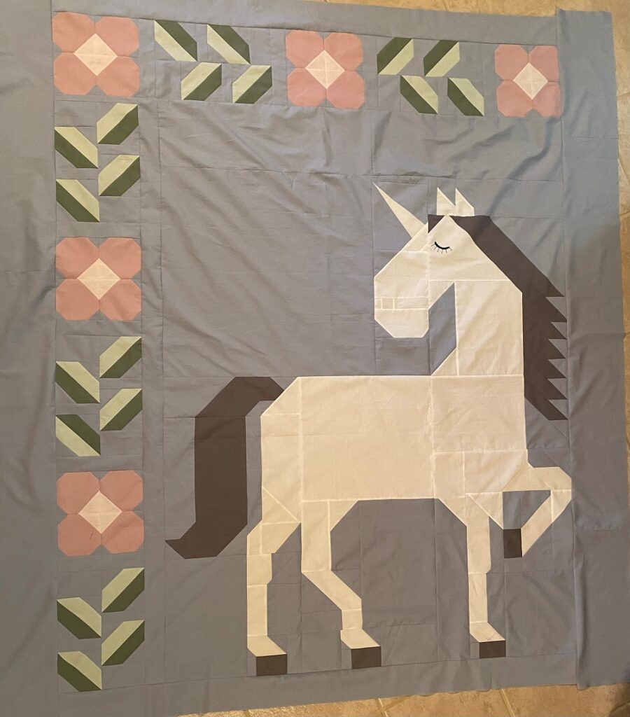 Unicorn Garden quilt top by Kim B.