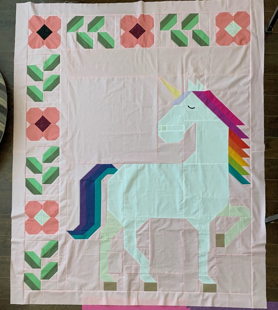 Unicorn Garden quilt top by Leanne M.