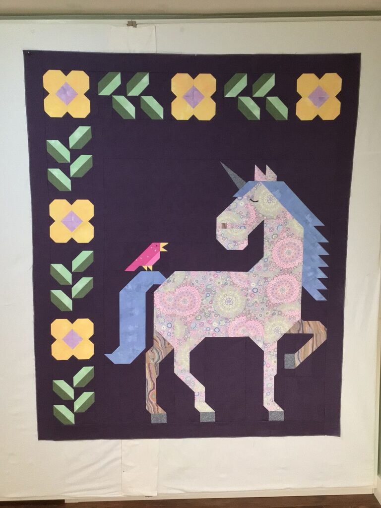 Unicorn Garden quilt top by Shannon S.