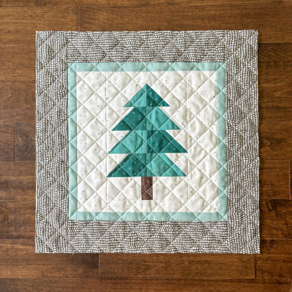 Apples & Beavers: quilted front panel for pillow cover, featuring an evergreen tree